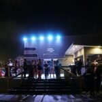 Crowd gathered outside an event venue at night